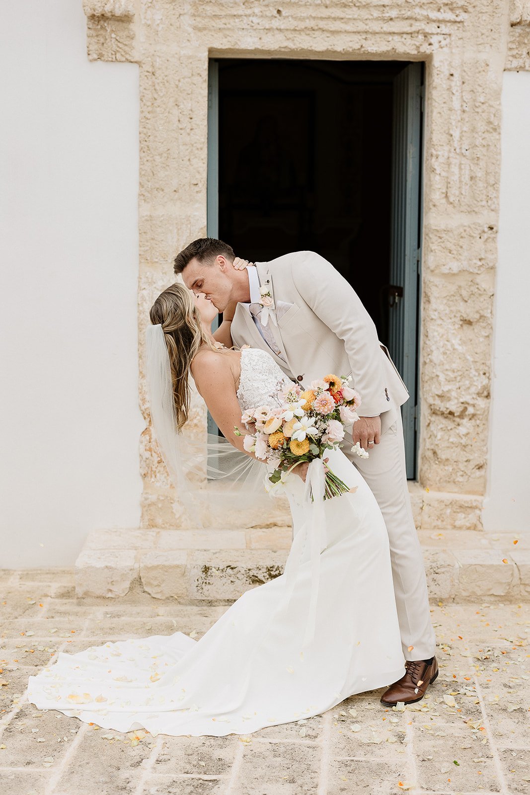 A kiss at a stone doorway of the masseria, Apulia elopement