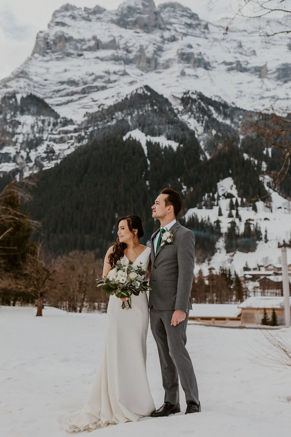 A couple in the snow beneath the Swiss Alps, Switzerland elopement