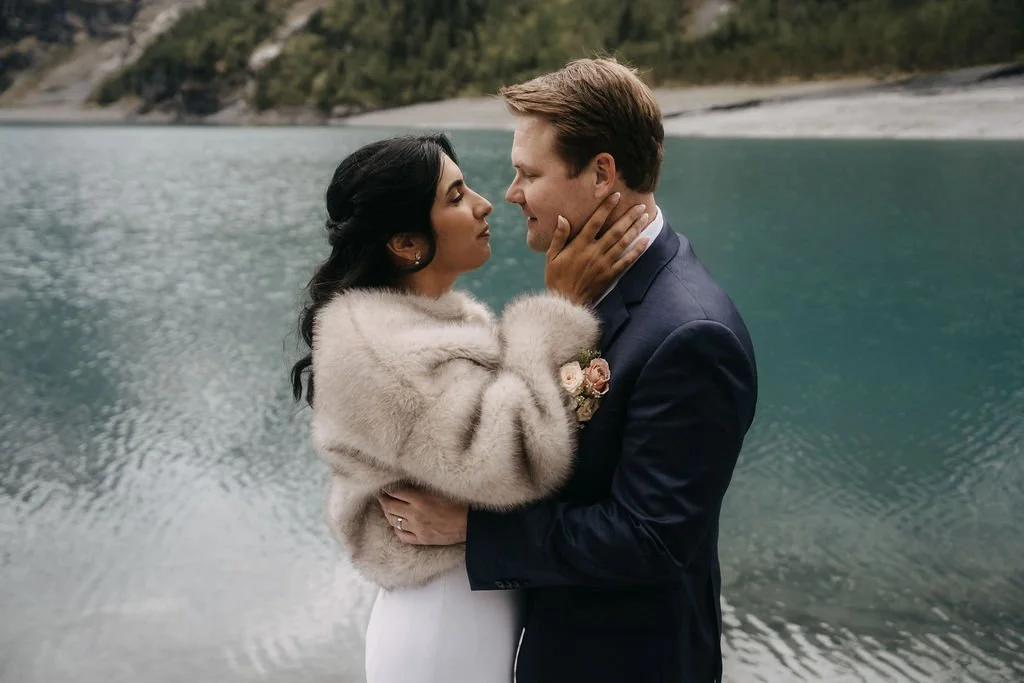 A couple embracing by the water in the mountains, Switzerland elopement