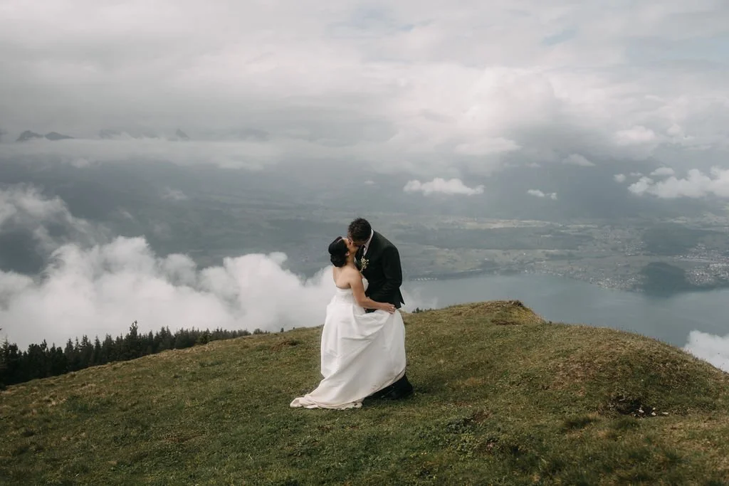 A couple embracing on an alpine meadow above the clouds, Switzerland elopement