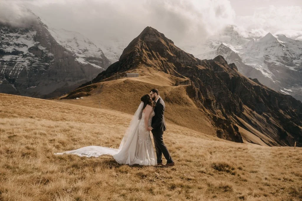 A couple on a golden mountain ridge beneath the Swiss peaks, Switzerland elopement