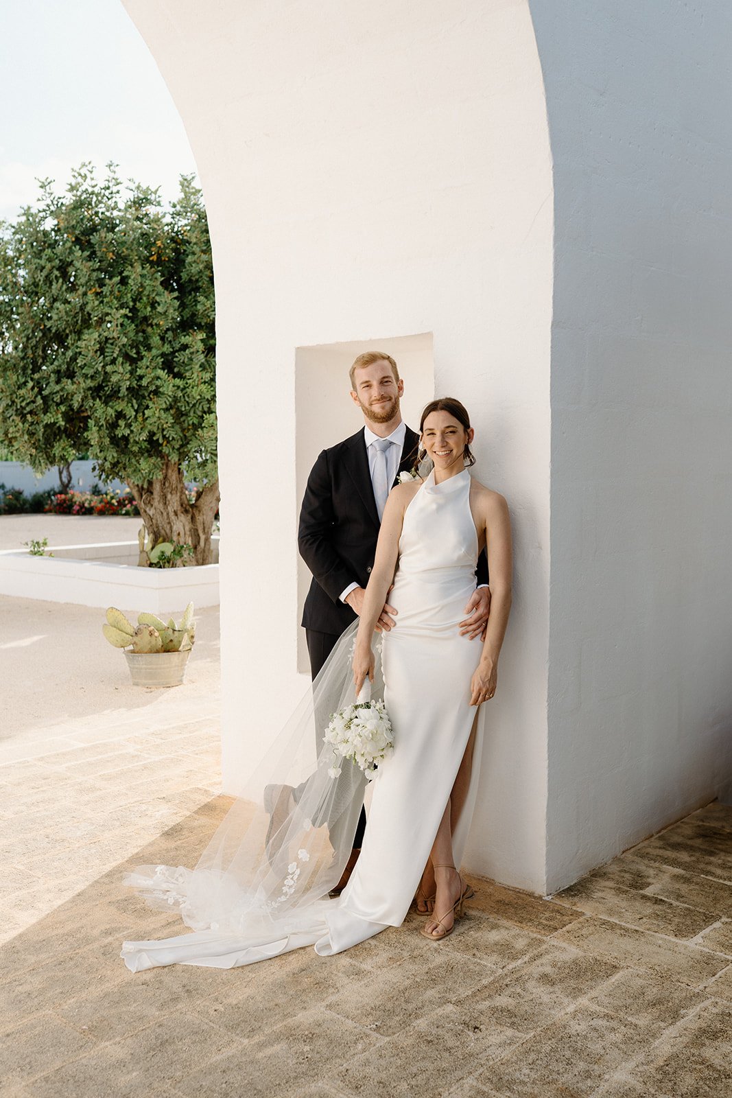 A couple in a whitewashed archway at Masseria Le Torri