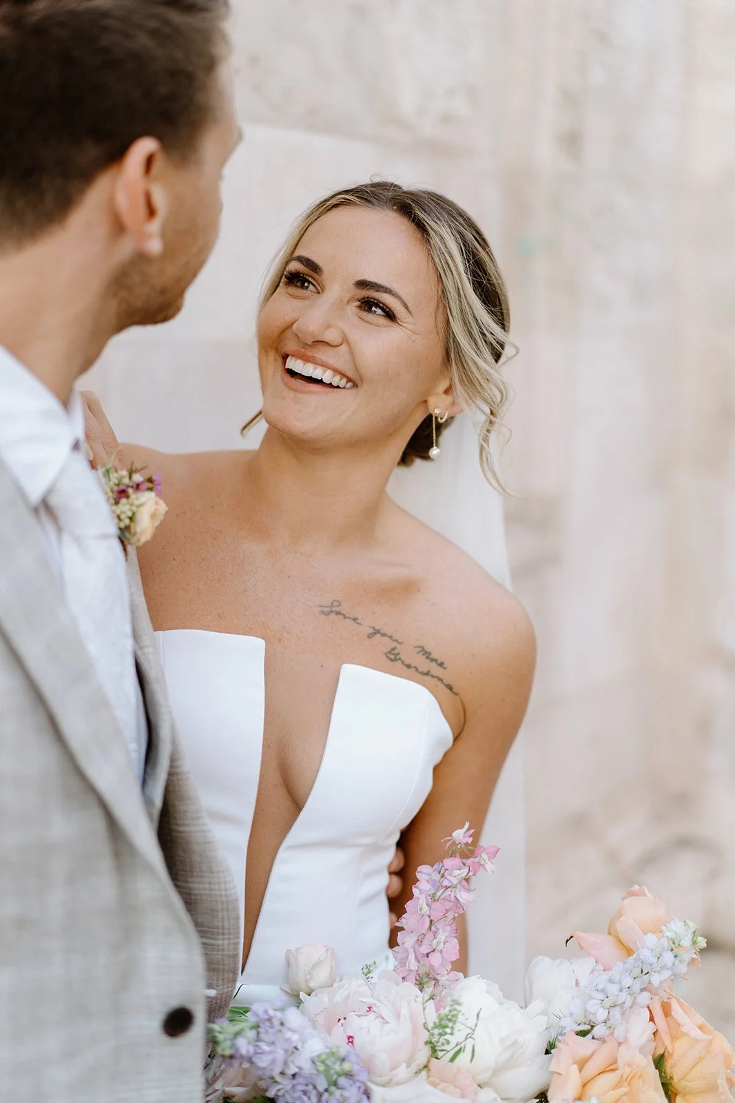 A bride smiling with a pastel bouquet at the masseria, Apulia elopement