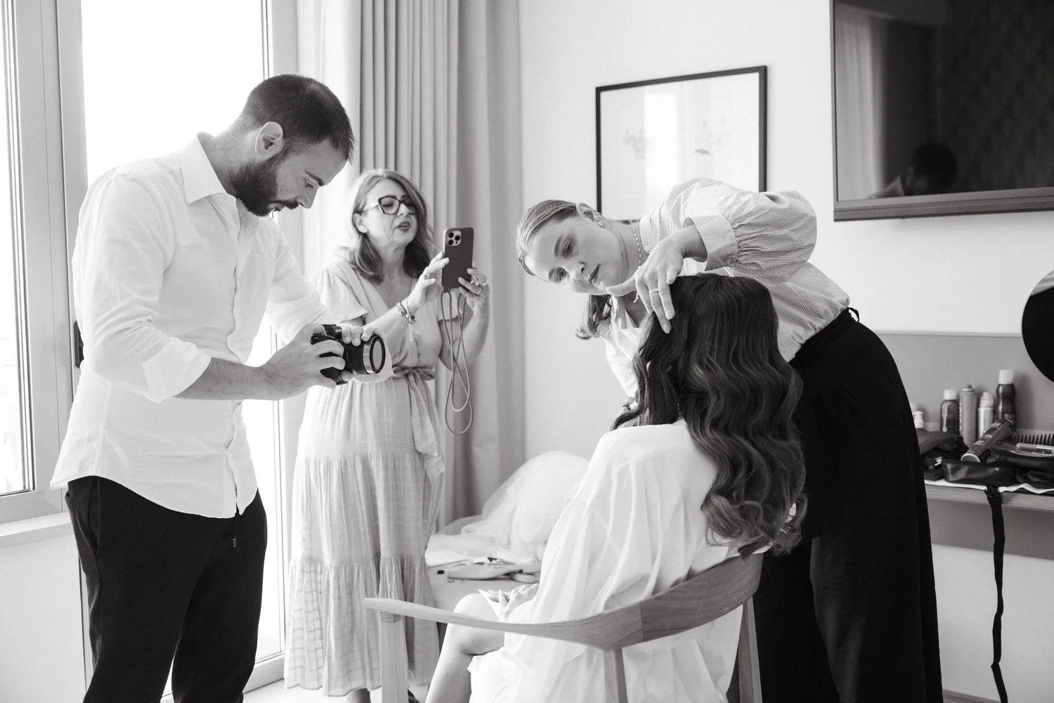 A local hairstylist at work while the photographer shoots