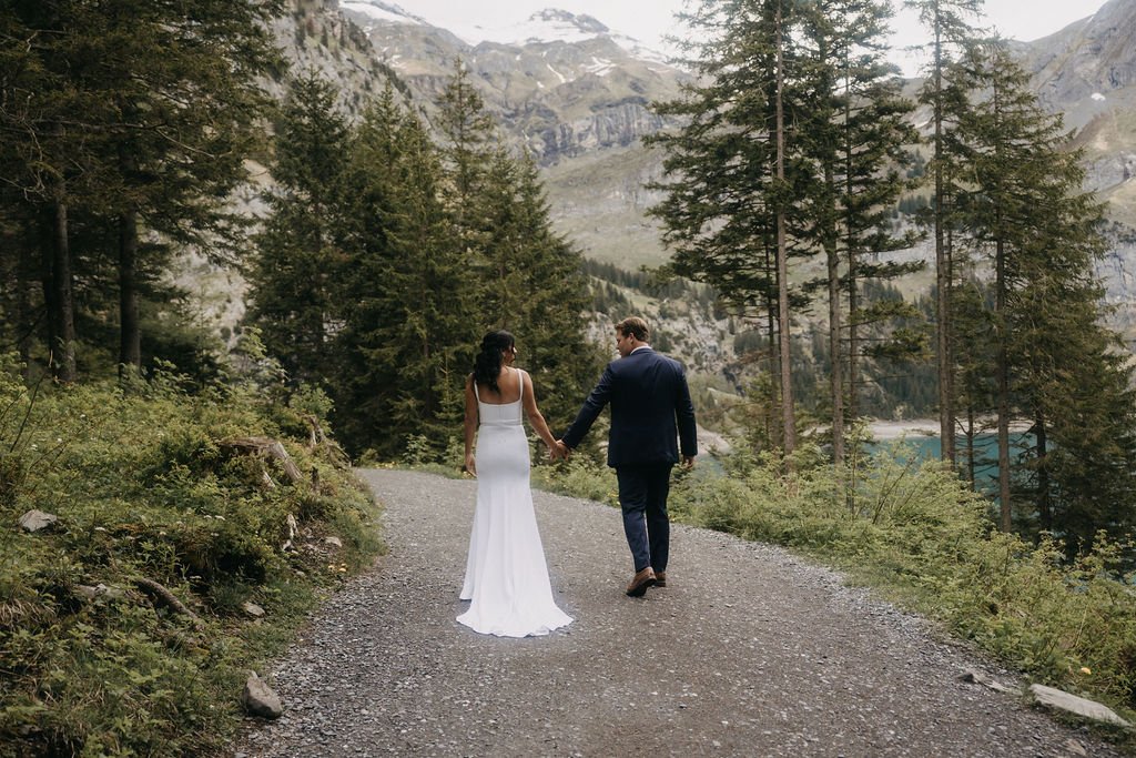 A couple walking along a forest path in the Swiss mountains, Switzerland elopement