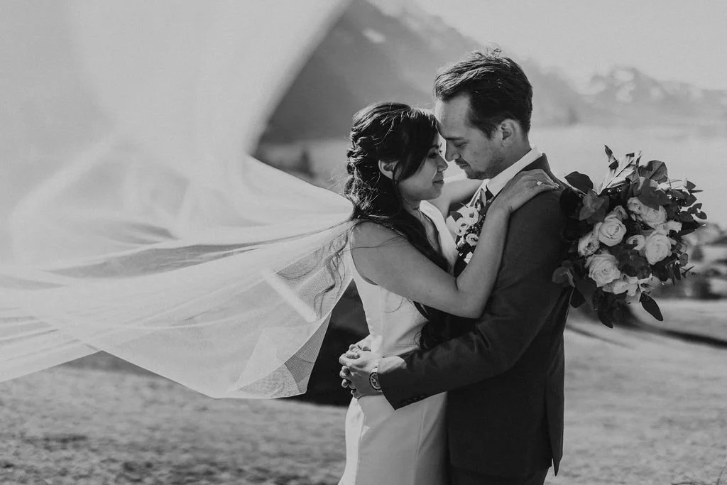 A black and white portrait of a couple with a flowing veil, Switzerland elopement